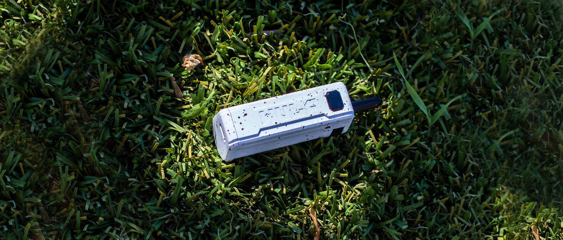 Wulf Mods UNI S oil Cartridge Vaporizer laying down outside on grass 