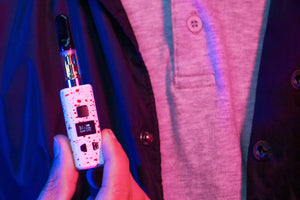 Man holding the Wulf KODO Pro Cartridge Vaporizer inside photo studio