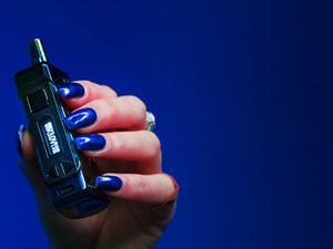 Woman holding UNI Pro Max in front of blue studio background